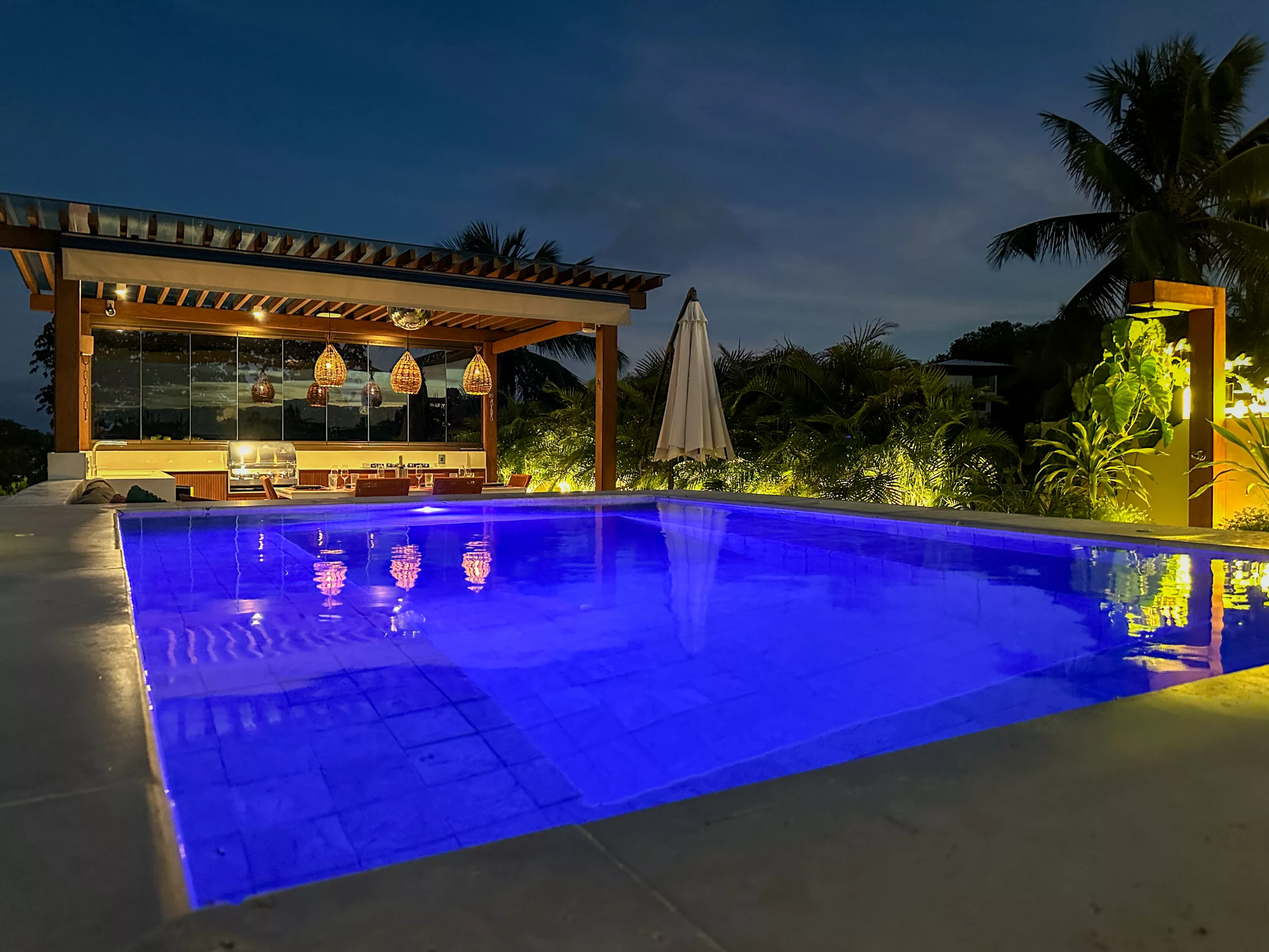 Private rooftop whirlpool and terrace illuminated at night